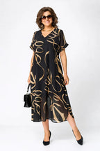 Women's black midi dress with gold swirl print, V-neck, short sleeves, draped hem
