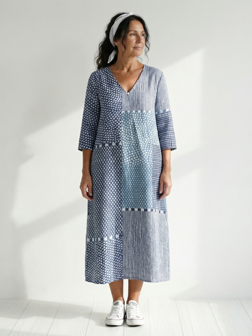 Blue patchwork midi dress with V-neck, 3/4 sleeves, and patch panel details