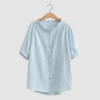 Lightweight cotton shirt in light blue, short sleeves, button front, ruffled crew neck.