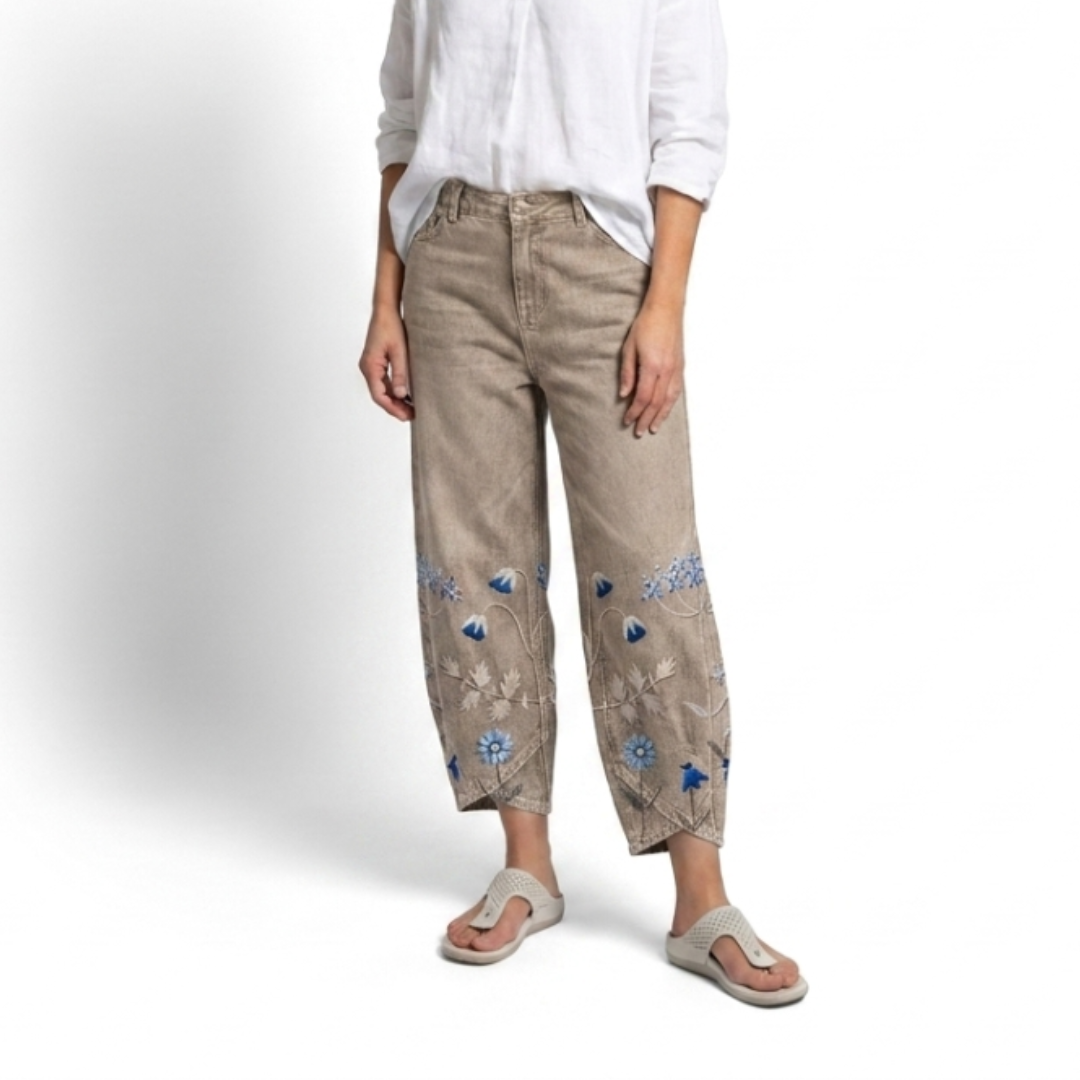 Beige casual trousers with blue-and-white floral embroidery panels on the sides