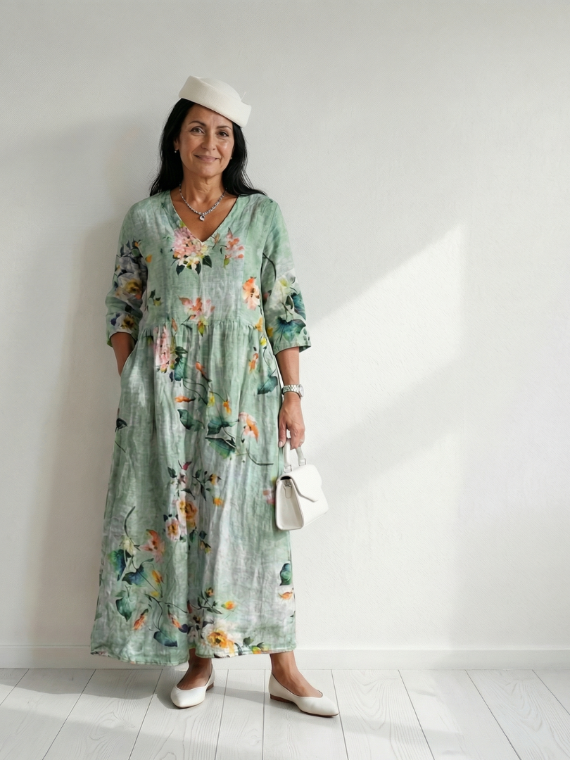 Sage green midi dress with floral print, gathered waist, three-quarter sleeves