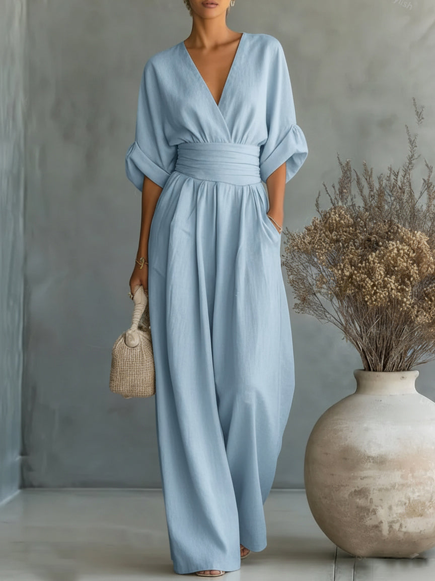 Light blue V-neck high-waist jumpsuit with cinched waist and wide-leg flow, dolman sleeves