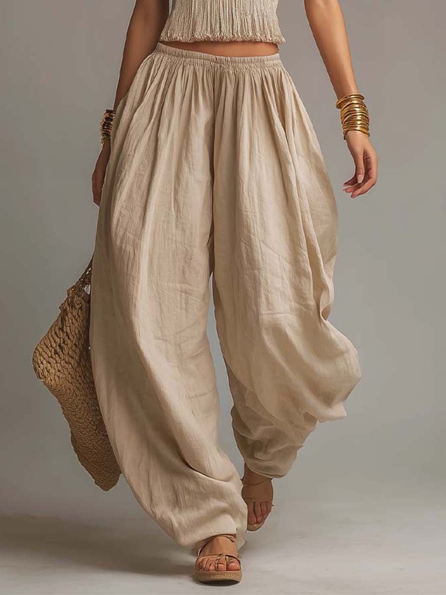 Beige halter two-piece set with fringe crop top and relaxed balloon pants, full length