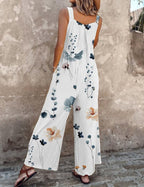 White sleeveless wide-leg jumpsuit with blue and brown flower print