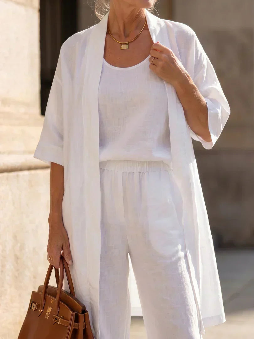 Elegant set with open long shirt over white top and wide-leg pants