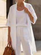 Elegant set with open long shirt over white top and wide-leg pants