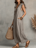 Grey sleeveless ruffle V-neck maxi dress, side view with tassel trim.