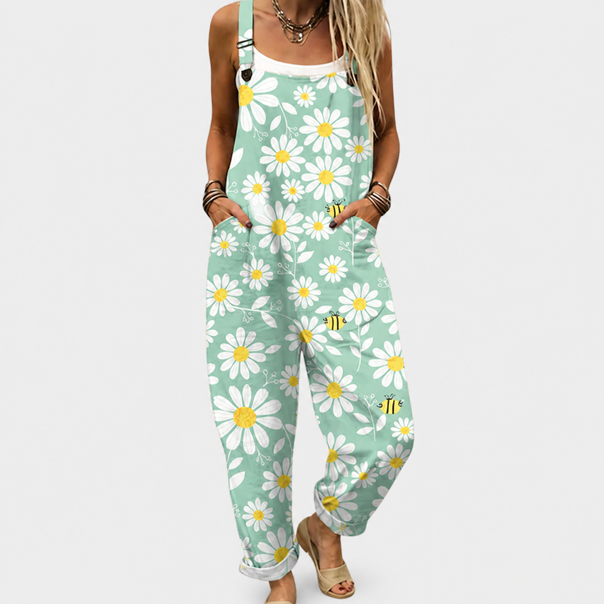 Green daisy-printed overalls with adjustable straps and front pocket, relaxed fit