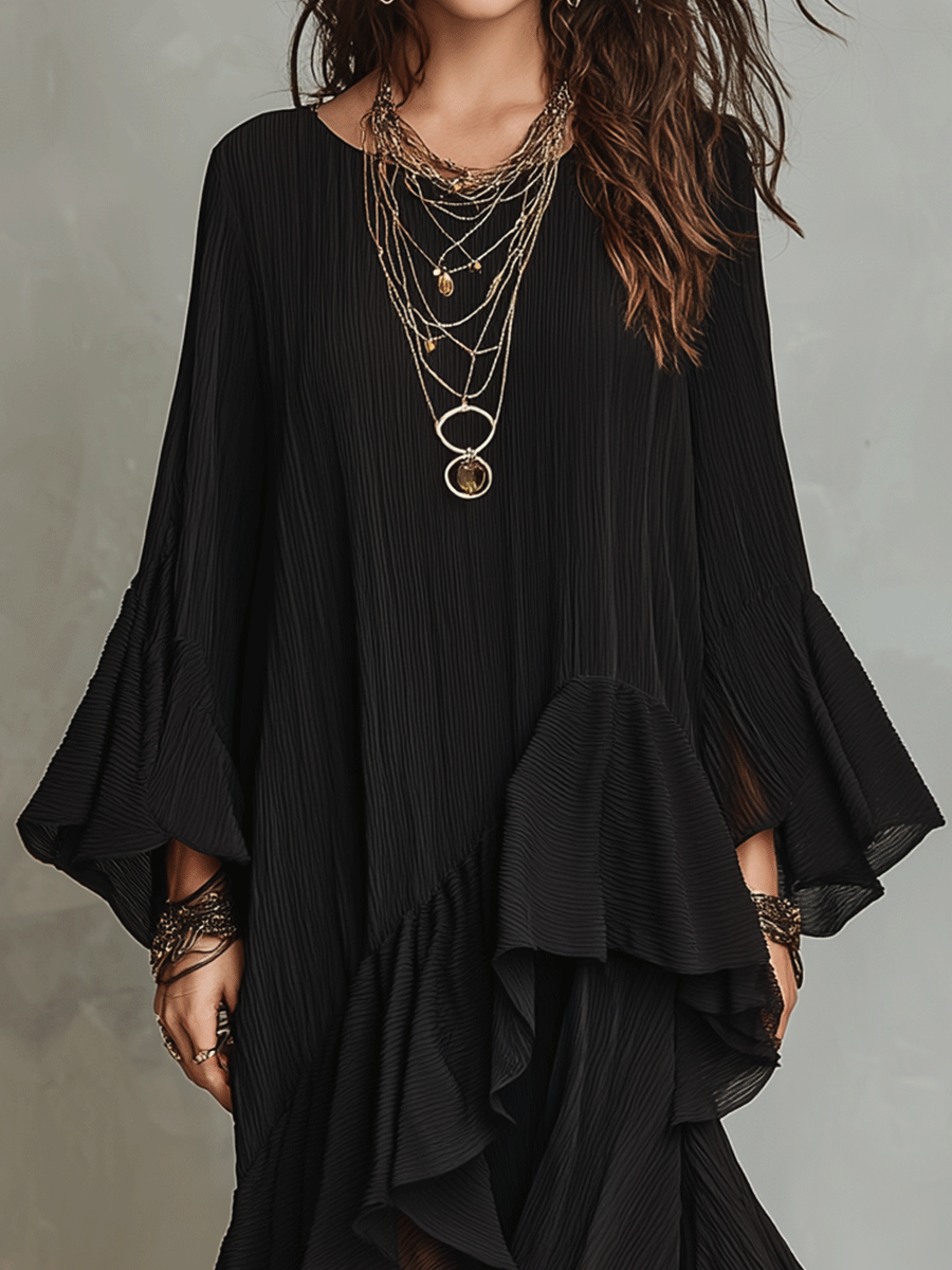 Black boho midi dress with pleated bodice, layered ruffle hem, and flared sleeves