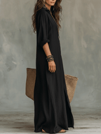 Black bohemian maxi shirt dress with button placket and elbow-length sleeves.