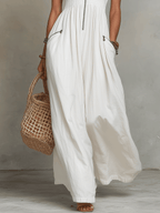 White zip-front sleeveless maxi dress with gathered skirt and side pocket zips