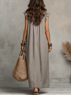 Grey sleeveless maxi dress with ruffle-trim neckline, back view.
