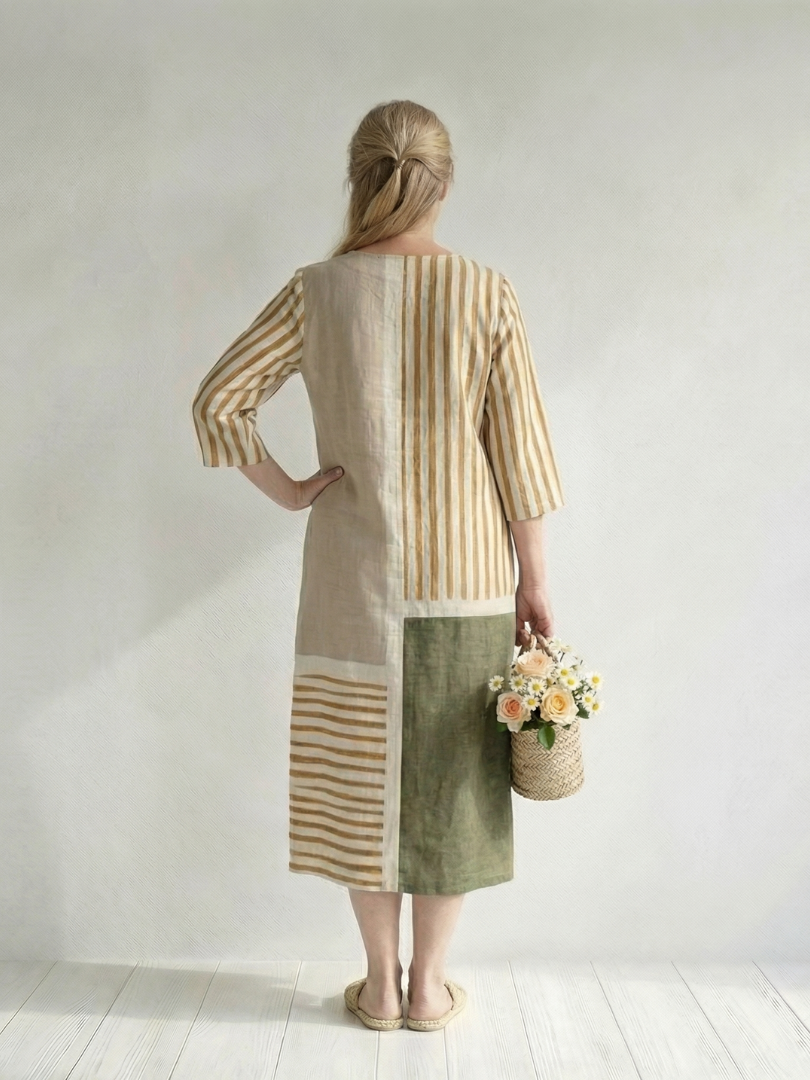 Women's striped midi dress back view with patchwork panels and three-quarter sleeves