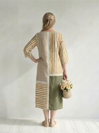 Women's striped midi dress back view with patchwork panels and three-quarter sleeves