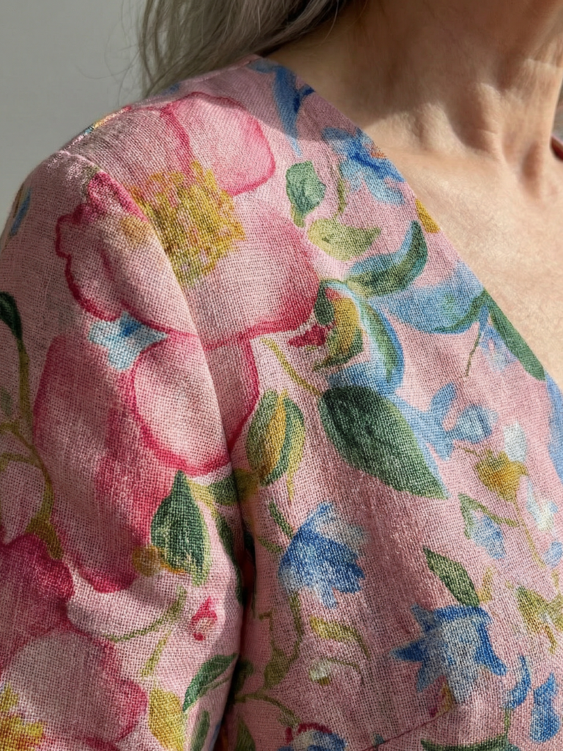 Floral dress fabric close-up: multicolor flowers on soft pink background, 3/4 sleeve