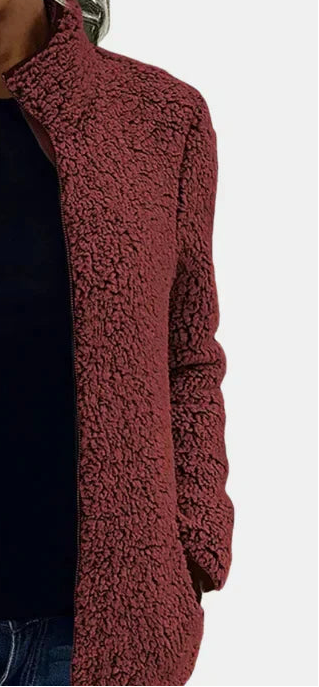 Side view of burgundy teddy fleece zip-up jacket sleeve and front pocket