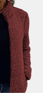 Side view of burgundy teddy fleece zip-up jacket sleeve and front pocket