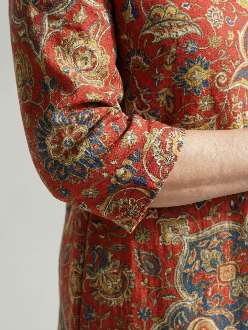 Red paisley-patterned sleeve and bodice detail on a patchwork midi dress