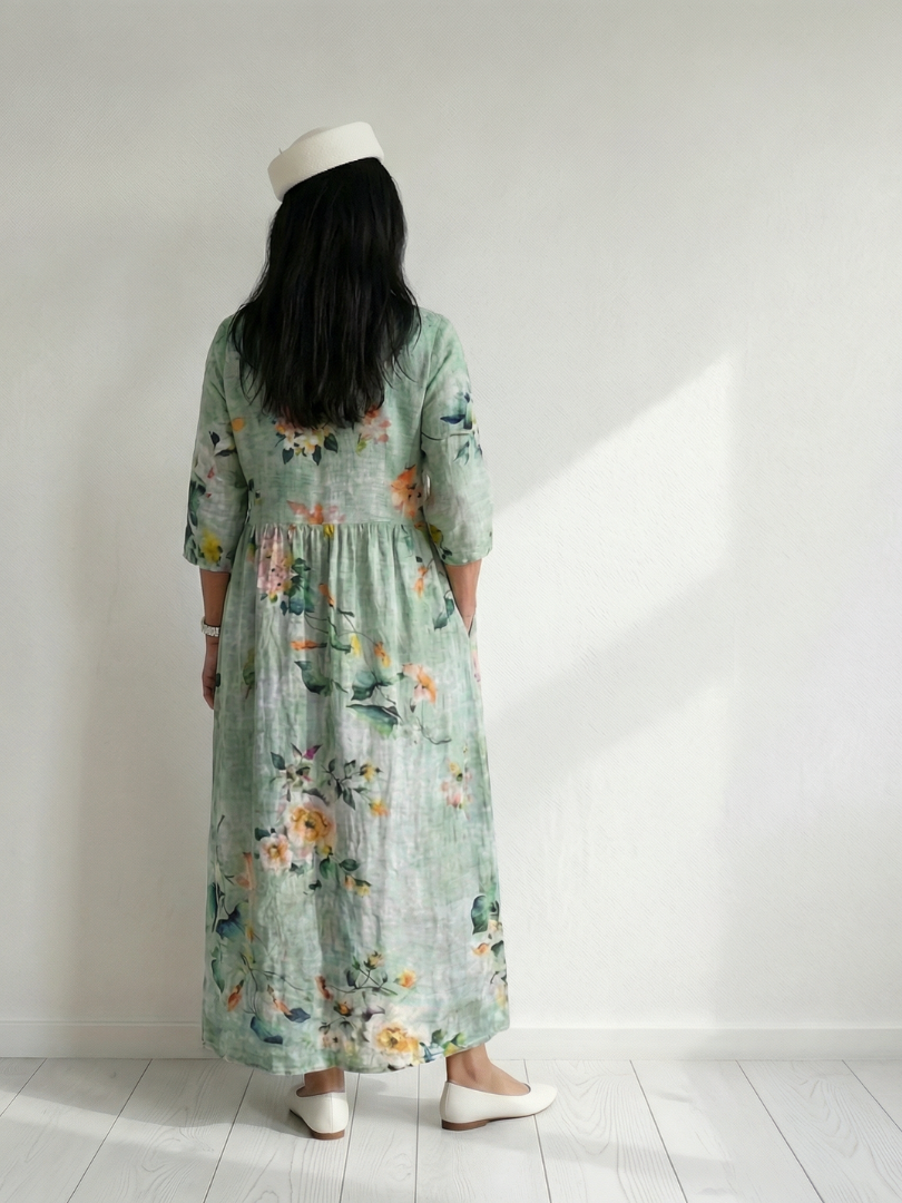 Sage green midi dress, floral back view with gathered skirt and elastic sleeves