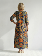 Elise floral midi dress, back view with navy and orange ornate print and 3/4 sleeves