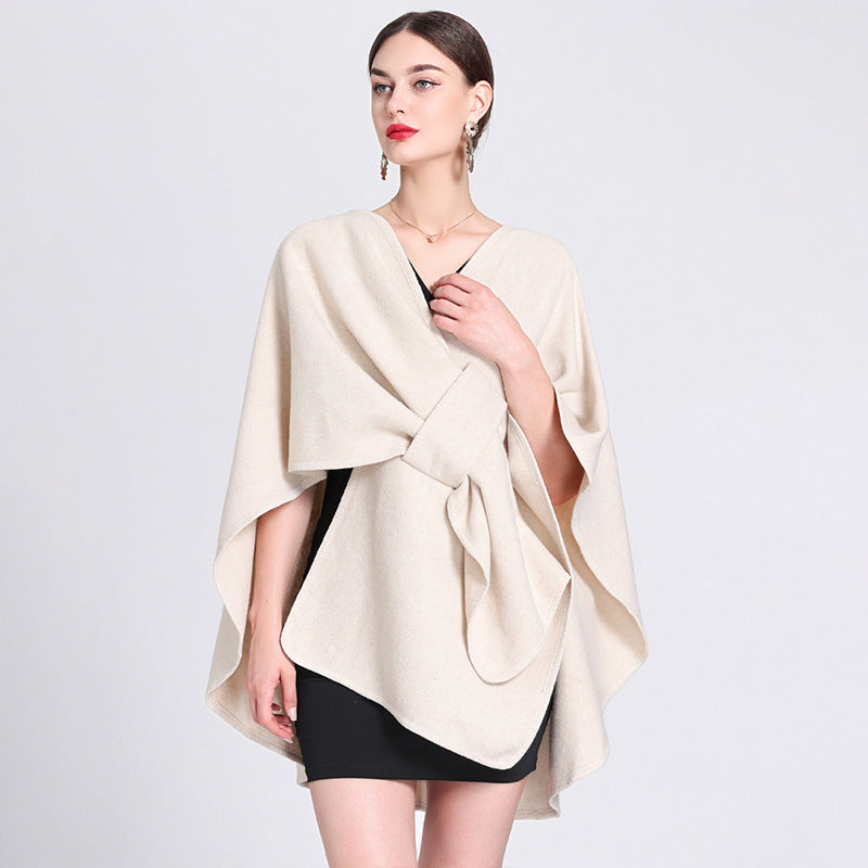 Light beige caped fleece shawl with V-neck and waist tie, loose poncho drape.