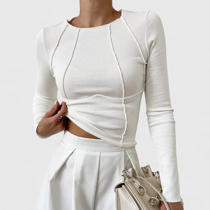 White ribbed knit long-sleeve top with round neck and draped asymmetrical hem