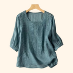 Teal embroidered blouse with round neck, three-quarter sleeves, textured yoke detail