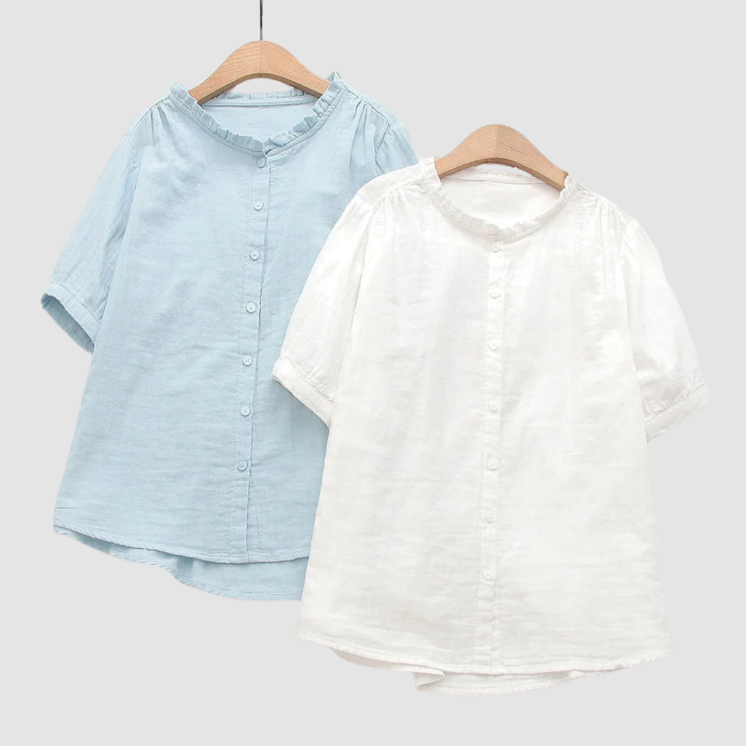 Two lightweight cotton shirts in light blue and white, short sleeves, button fronts, ruffled crew necks.