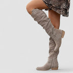 Beige orthopedic western boot with tall slouch shaft, side zipper panel, and ankle snap strap.