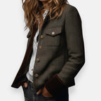 Olive tailored jacket with notch collar, gold buttons, chest pocket, and dark cuffs