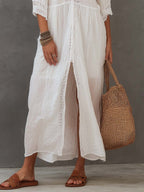 White lace-embroidered midi dress detail with front panel and side slit