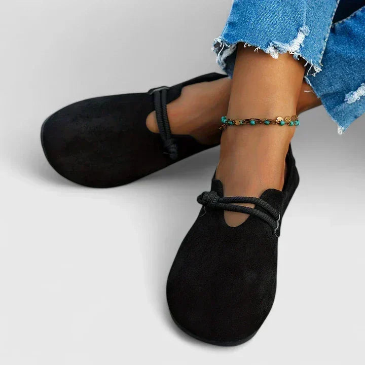 Black suede slip-on loafers with top tie strap