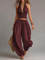 Burgundy halter two-piece set with fringe crop top and loose balloon pants, sleeveless