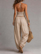 Beige two-piece set from the back: halter tie crop top and gathered balloon pants