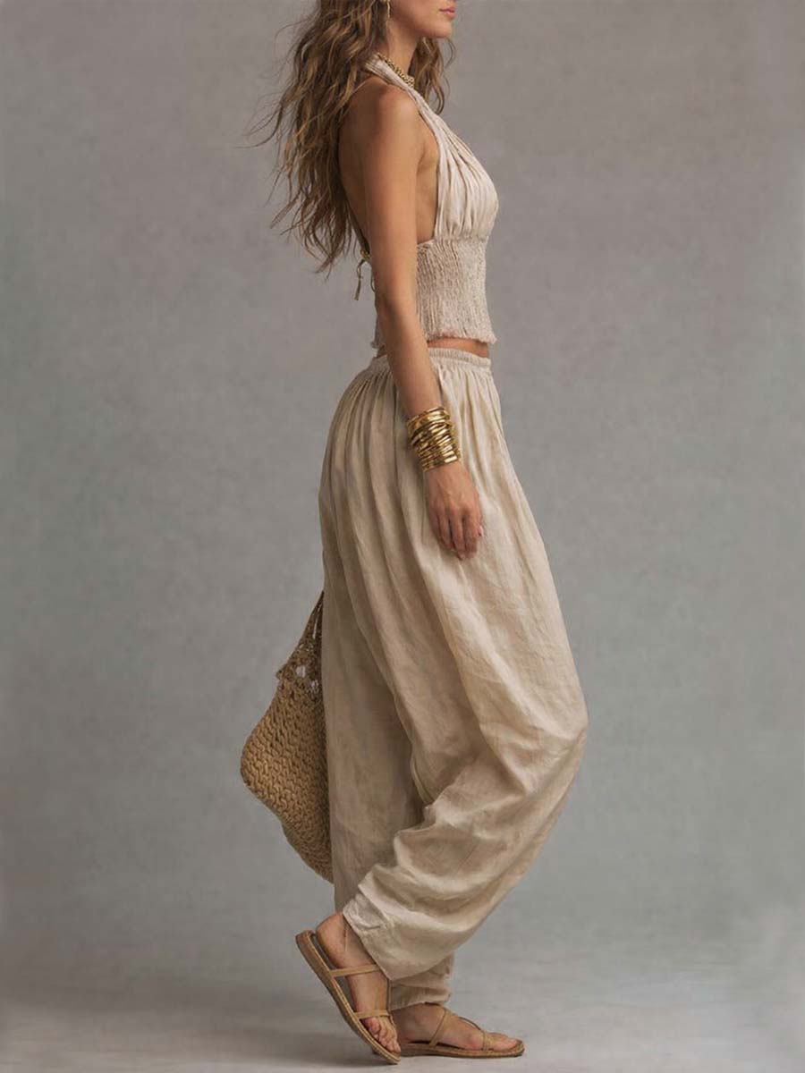 Beige halter two-piece set with fringe crop top and loose balloon pants, side view