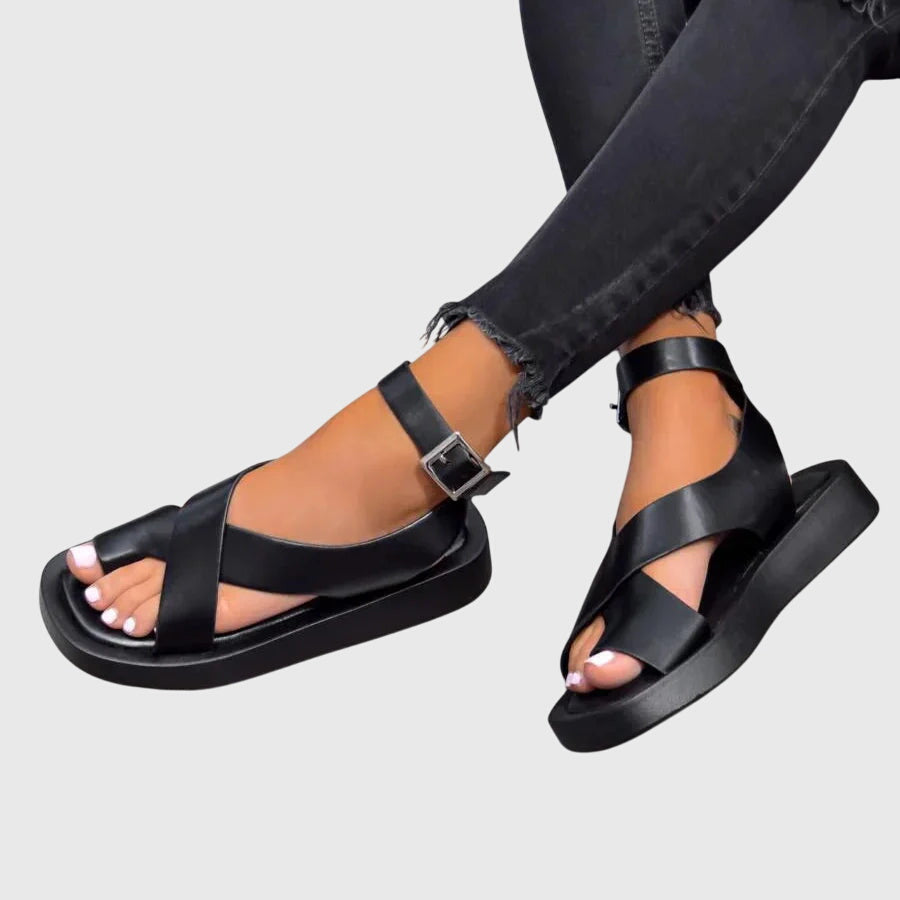 Black orthopedic sandals with wide cross strap and open toe