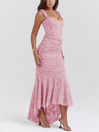 Pink floral sleeveless maxi dress with ruched bodice and draped asymmetrical hem.