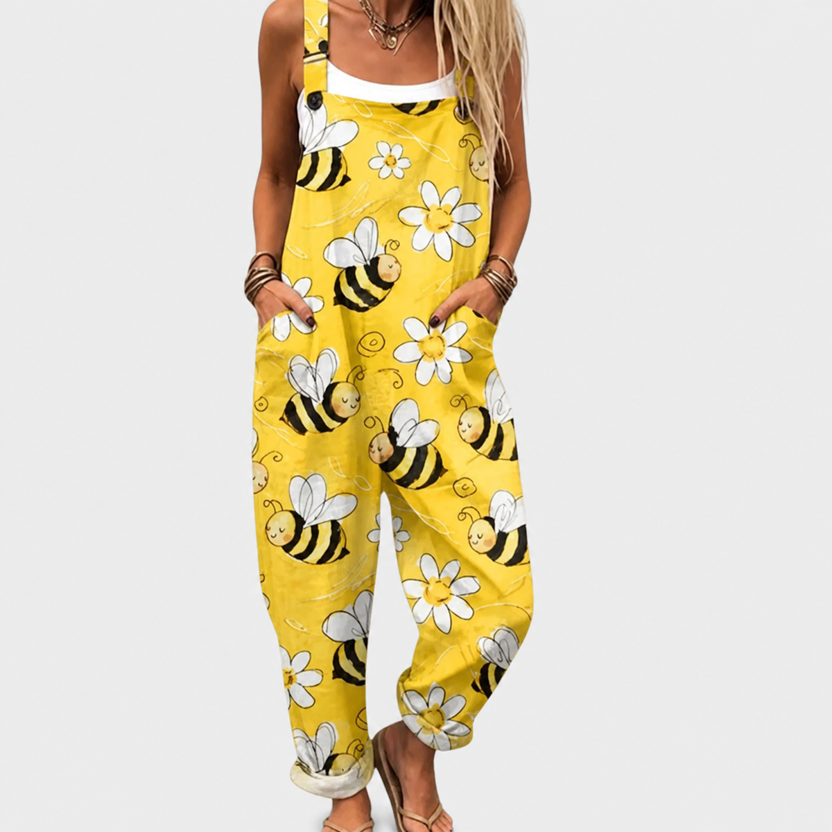 Yellow printed overalls with bee and flower pattern, bib front and adjustable straps