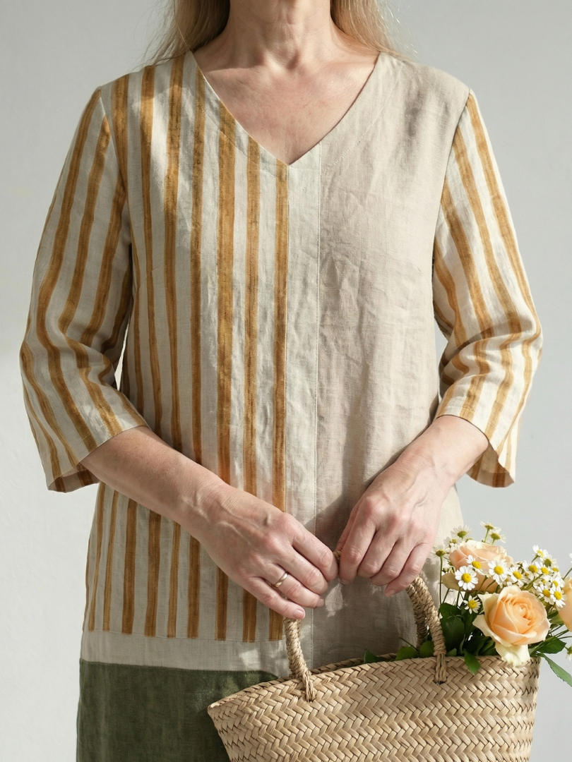 Women's linen midi dress close-up: V-neck, vertical stripe front, cuffed three-quarter sleeves