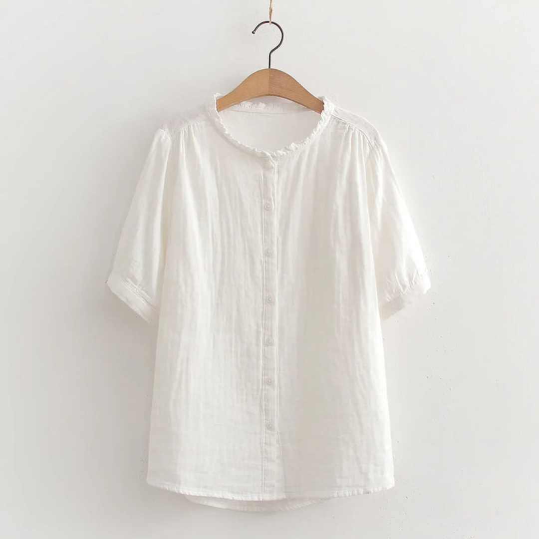 Lightweight cotton shirt in white, short sleeves, button front, ruffled crew neck.
