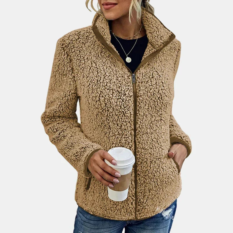 Beige teddy fleece zip-up jacket on model with front zipper and stand collar