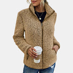 Beige teddy fleece zip-up jacket on model with front zipper and stand collar