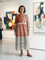 Rust brown midi dress with V-neck, three-quarter sleeves, mix stripes across skirt
