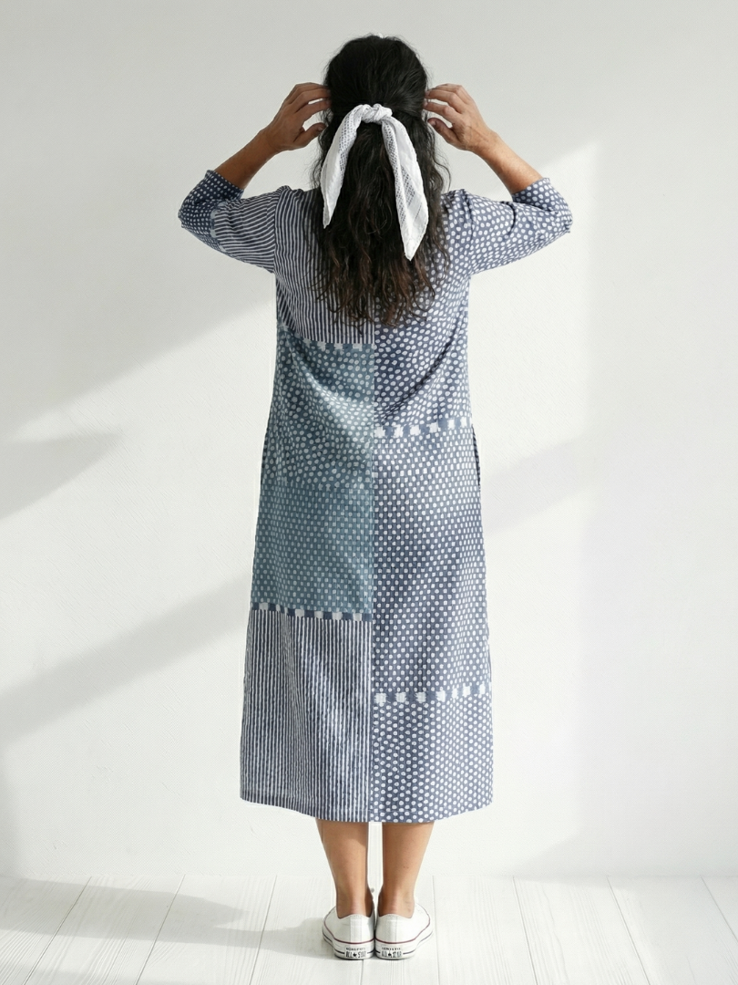 Blue patchwork midi dress back view with tied scarf detail at neckline