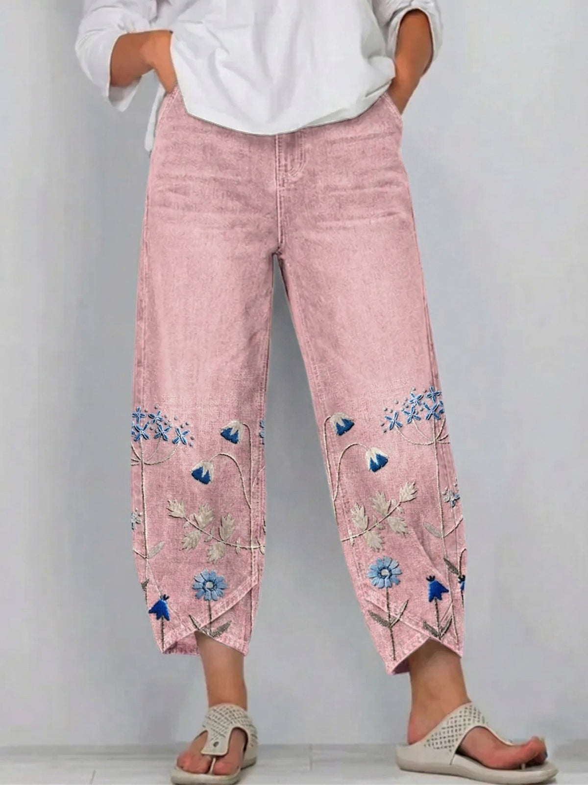 Pink casual trousers with blue-and-white floral embroidery panels on the sides