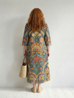 Floral midi dress back view in dark teal with colorful swirling floral print
