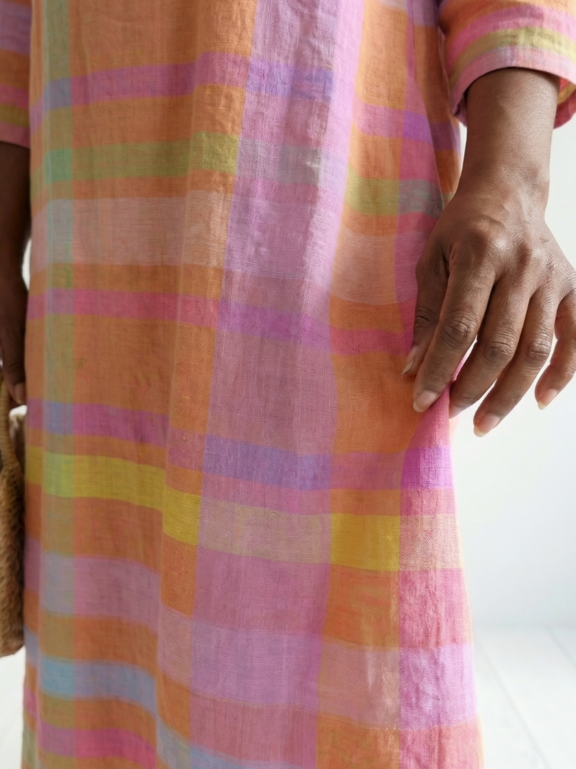 Pink, orange, green, and purple striped fabric detail on a midi dress