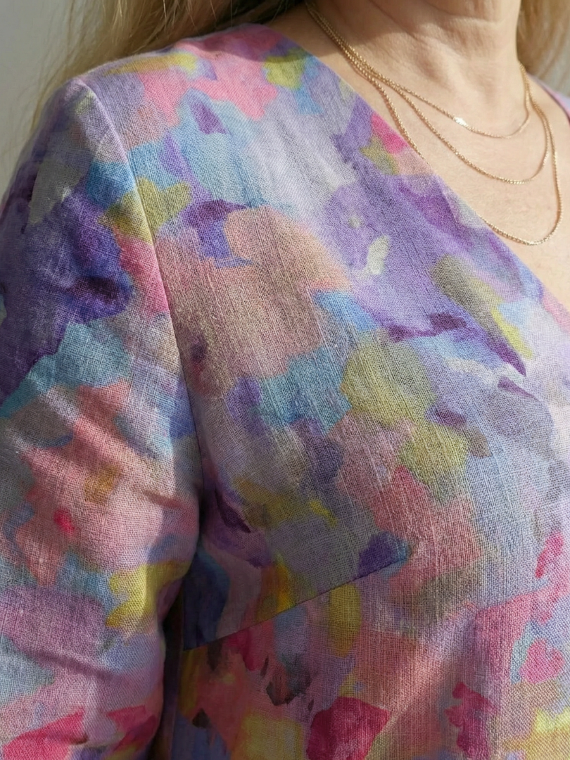 Multicolor abstract floral fabric detail on midi dress, V-neck area