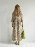 Floral scatter midi dress, back view, three-quarter sleeves and gathered skirt