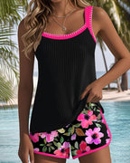 Two-piece beach tankini with black ribbed tank and purple trim, floral shorts